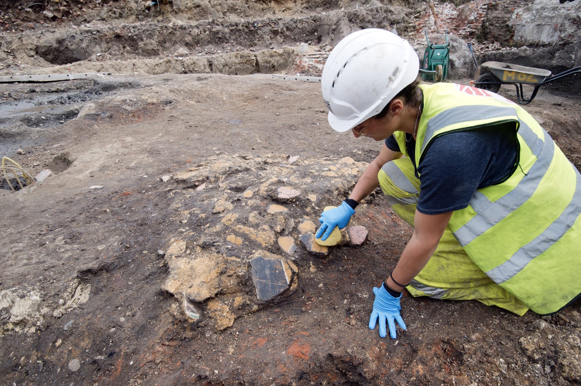 an archaeologist uncovers fragments of an ancient Roman fresco