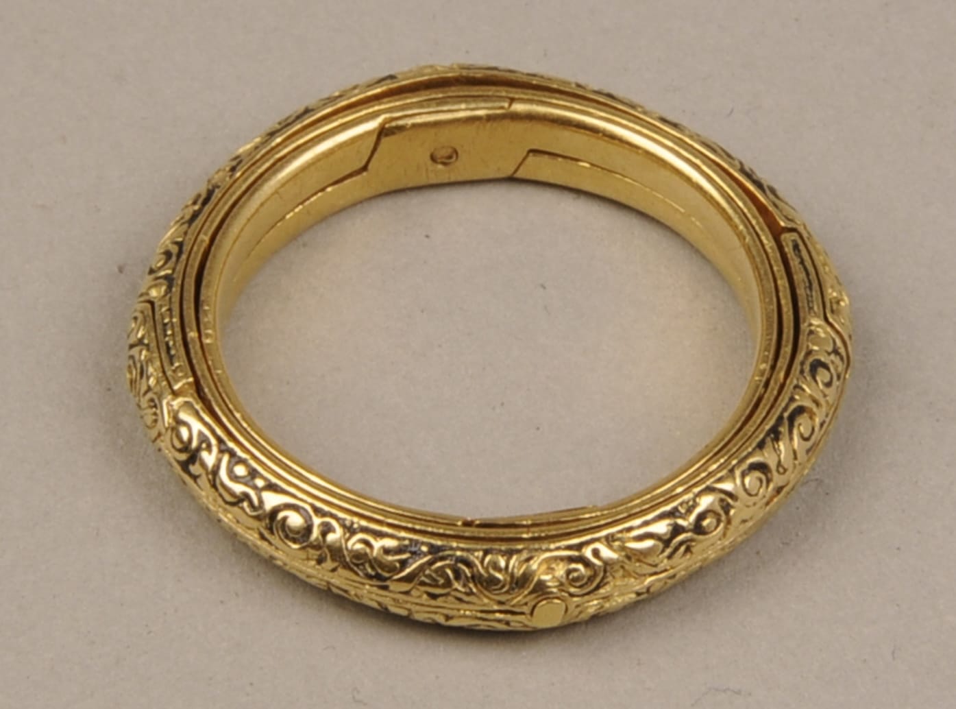 a photo of an armillary ring shown closed with the hinges visible inside