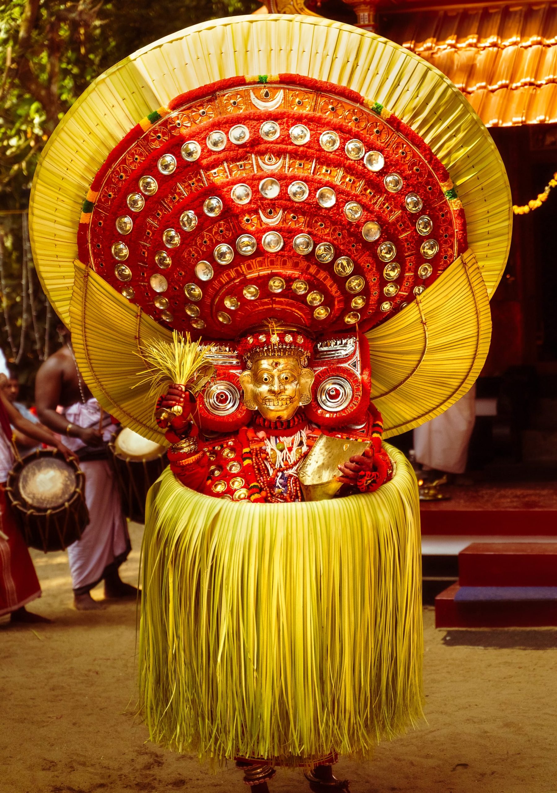 a photograph by Navneet Jayakumar of an elaborate ceremonial outfit worn by a performer for Theyyam, in Kerala, India